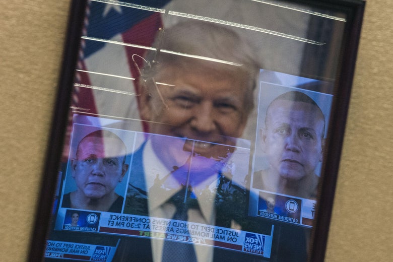 Mugshots of bombing suspect Cesar Sayoc are reflected on a portrait of President Donald Trump prior to a press conference at the Department of Justice in Washington, D.C. on October 26, 2018.